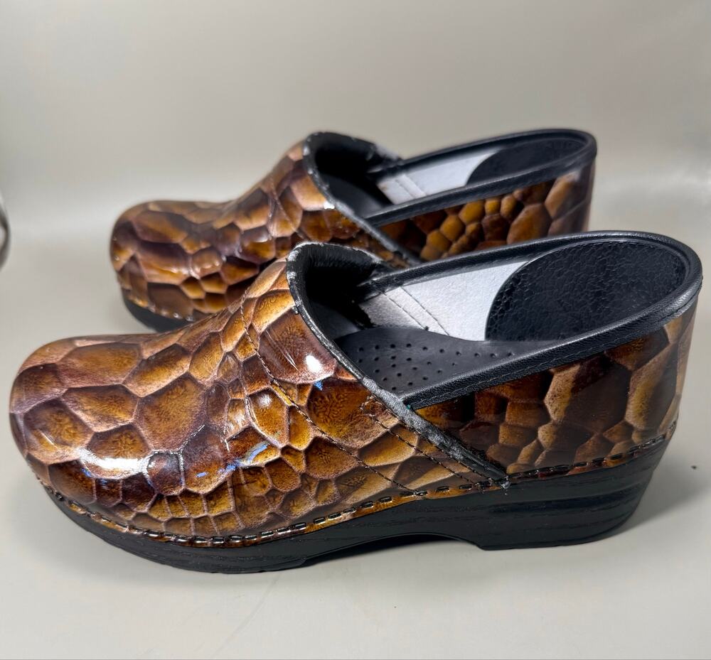 Dansko Professional Clogs in a brown patent leather "Tiger's Eye" reptile print.